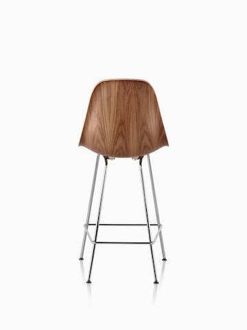 Eames Molded Wood Stool with a medium finish and silver legs, viewed from the rear. 