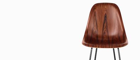 Upper half of an Eames Molded Wood Stool with a dark finish, viewed from the front. 