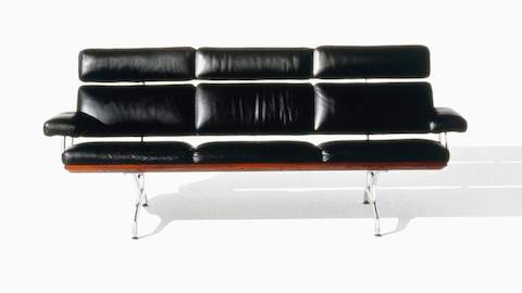Black leather Eames Sofa, viewed from the front. 