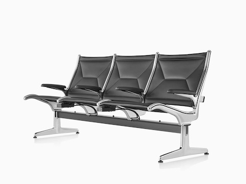Three connected black sling seats positioned at an angle with integrated power source that includes USB-C port, USB-A port, and AC power outlet.