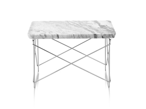A rectangular Eames Wire Base Low outdoor table, showing the two-centimeter-thick marble top with a beveled edge. 