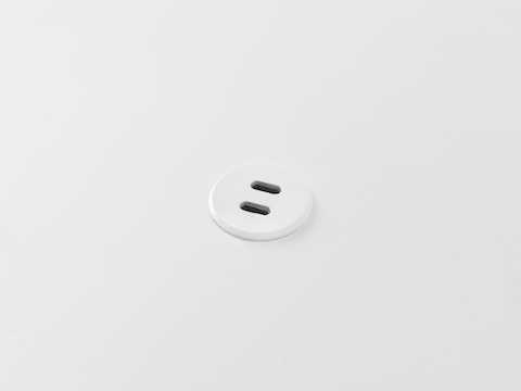Ello Micro surface-integrated dual port USB-C power solution charging a laptop shown in white.