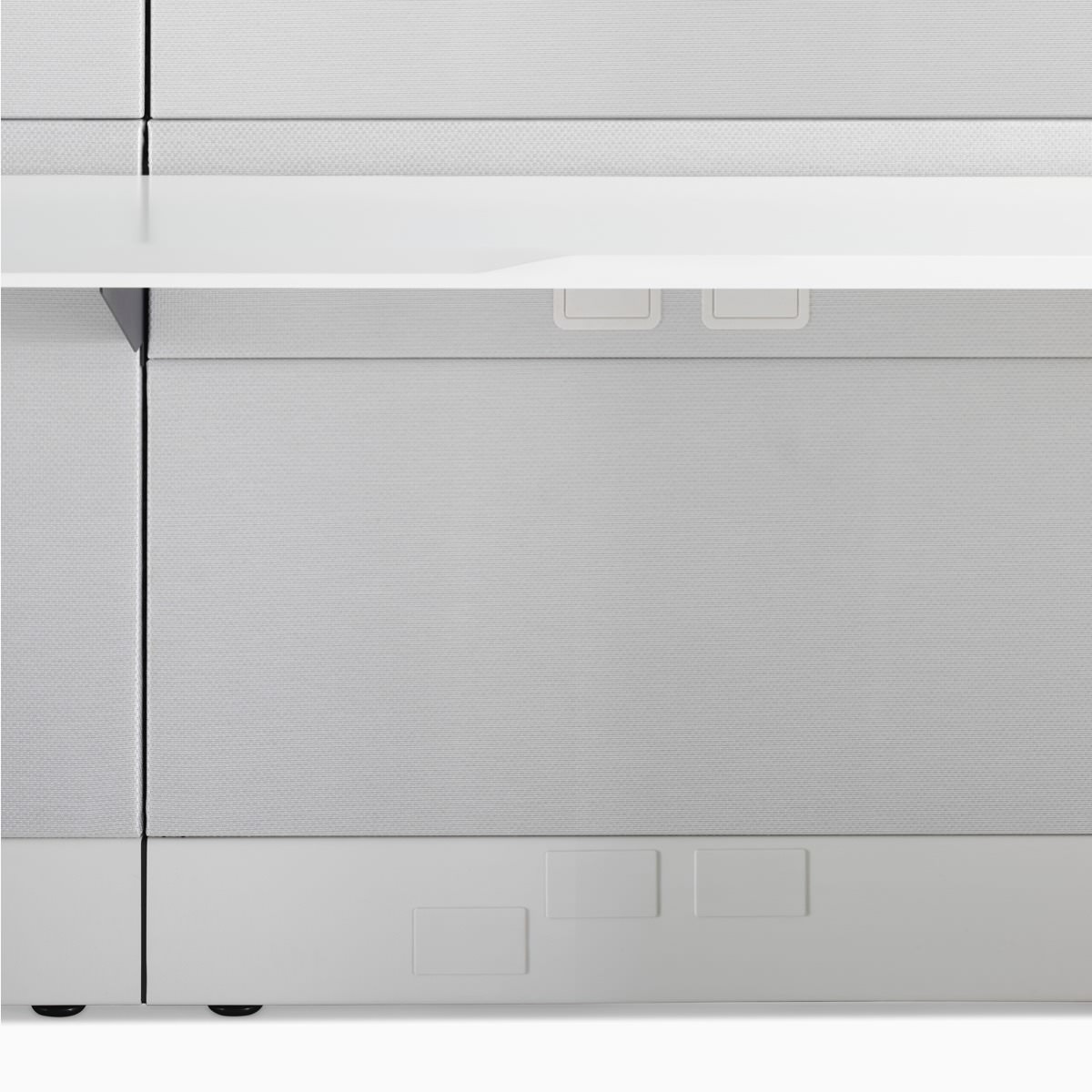 A detail image of Ethospace work surface in a white finish and attached to light gray fabric tiles.