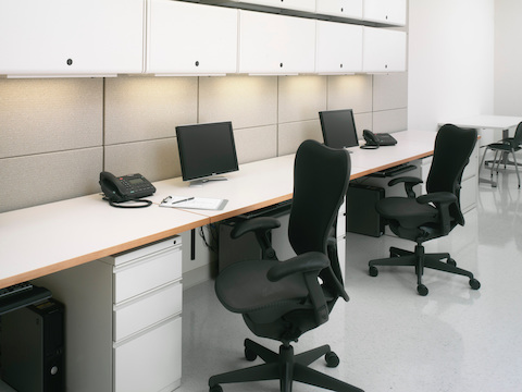 Ethospace Nurses Station storage, surfaces, and tiles create two work points in a healthcare administrative area.