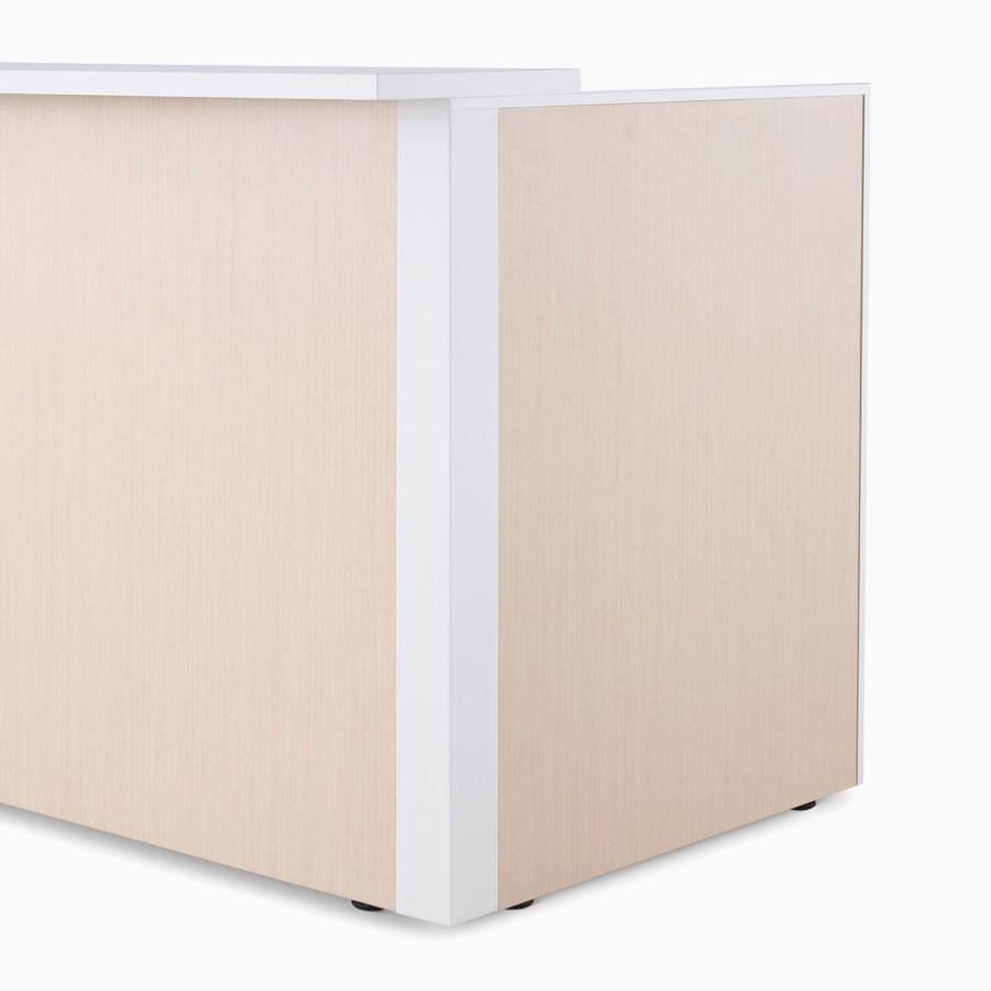 Detail of Ethospace Nurses Station in a light wood finish featuring the outside corner and transaction surface.