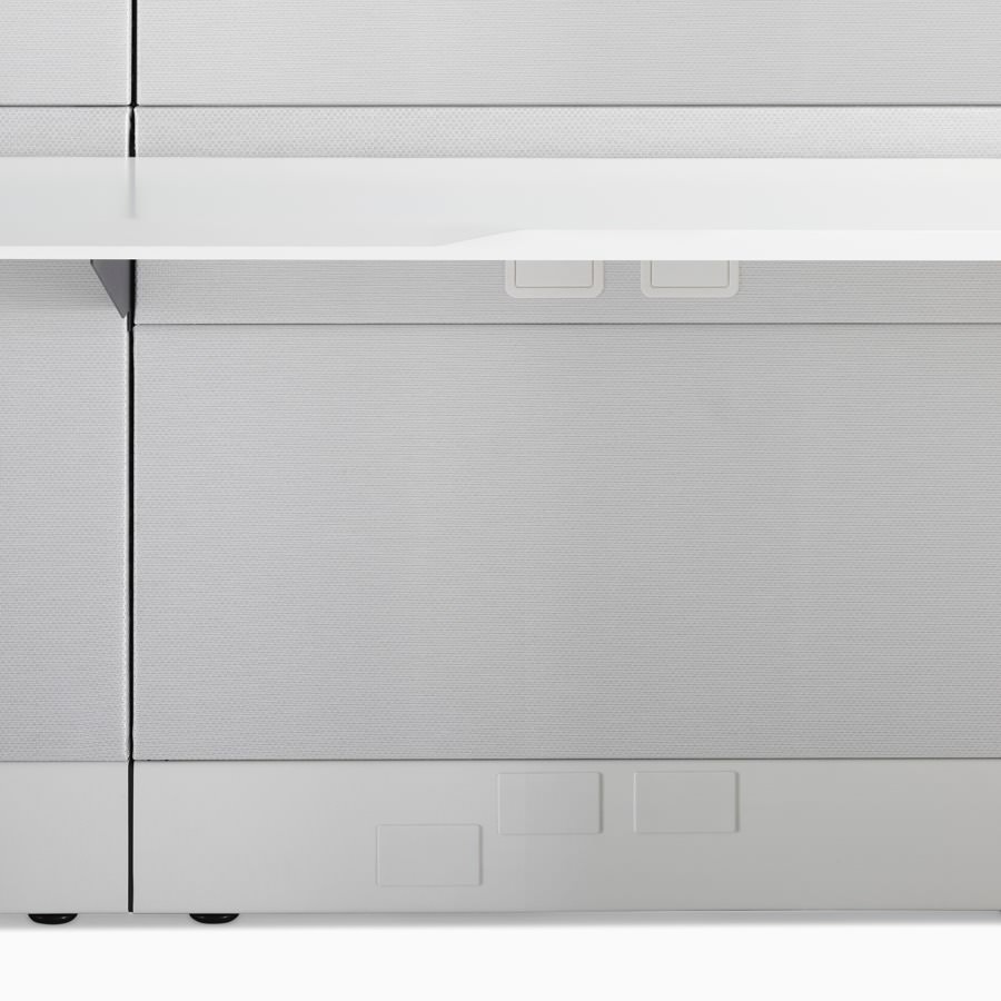 A detail image of Ethospace work surface in a white finish and attached to light gray fabric tiles.
