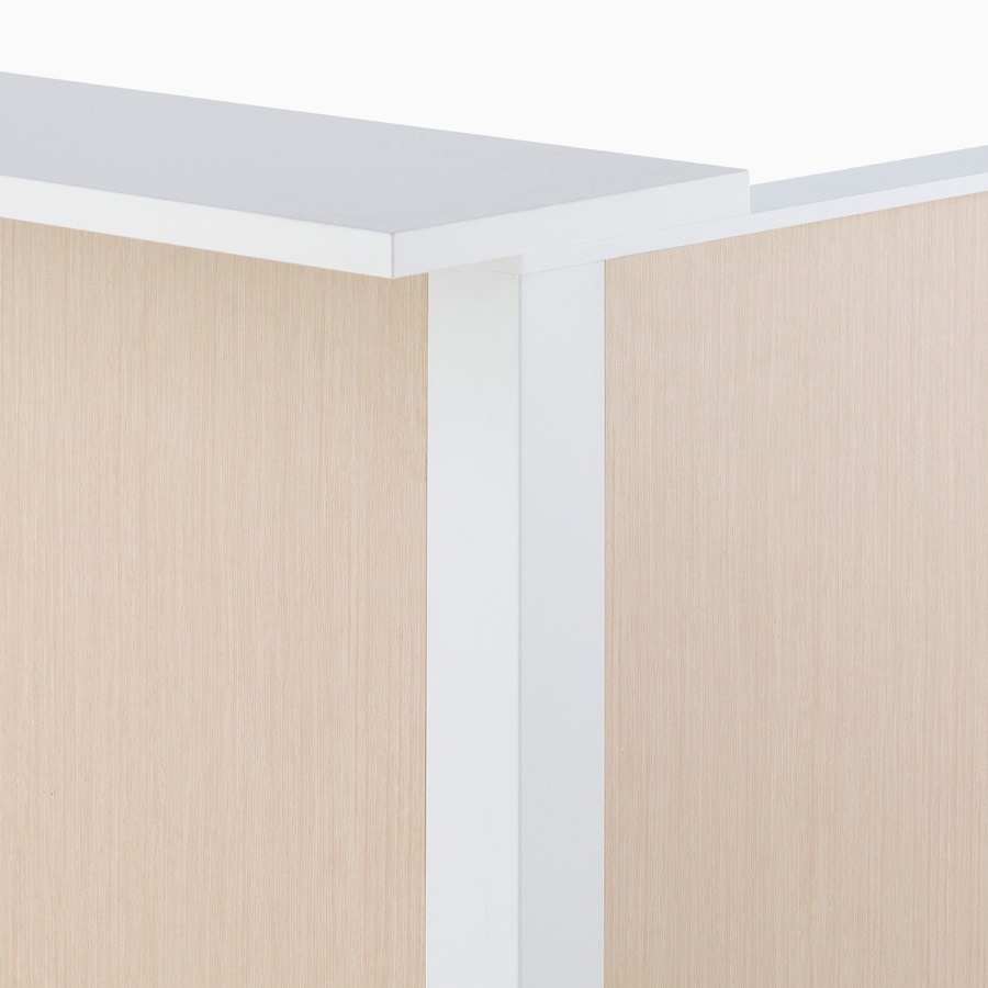Detail of Ethospace Nurses Station in a light wood finish featuring a white transaction surface.