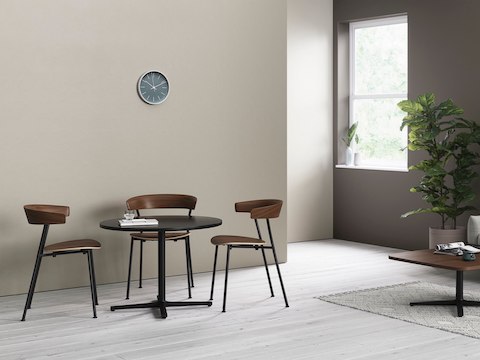 Two Everywhere Tables in an informal seating area, with wooden Leeway Chairs.