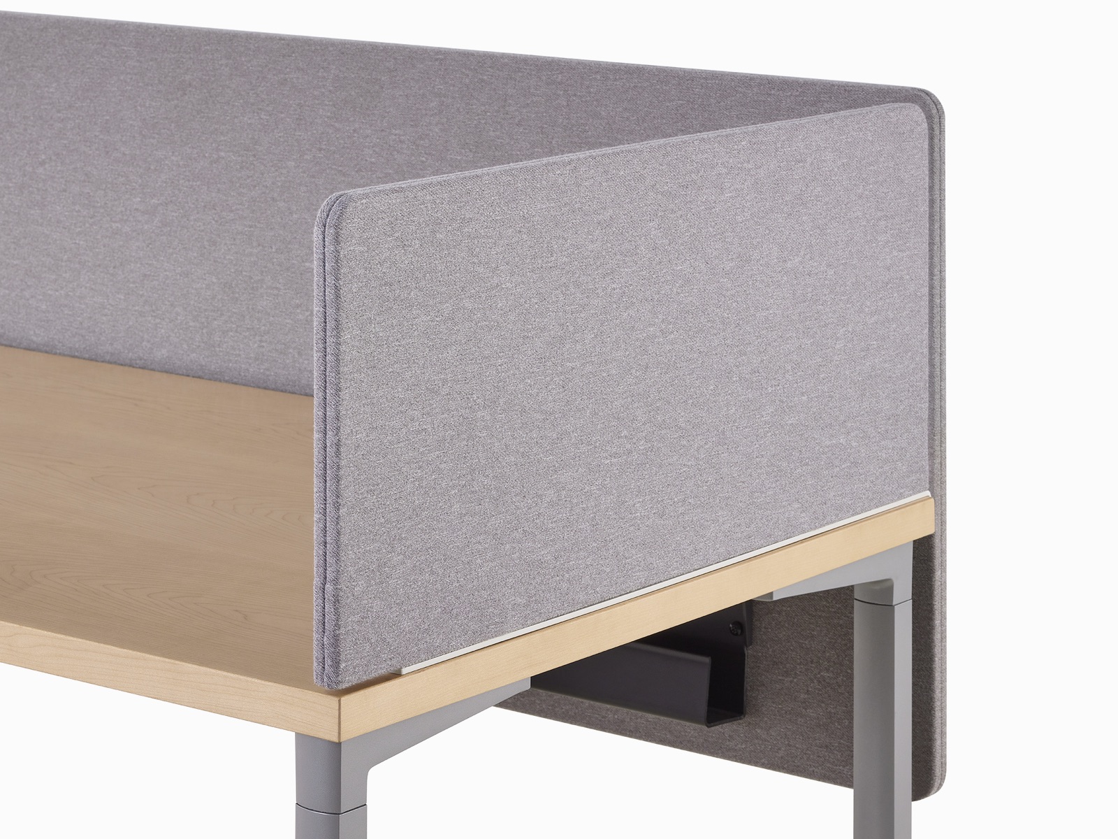 Close-up of a gray fabric delineation screen at the end of a workstation with a surface-attached privacy screen.