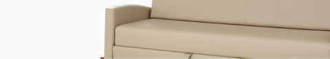Detail view of a Gemma Double Sleep Sofa in tan textile with white arm caps.