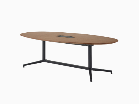 An oval Y-base Headway Conference Table with a medium wood top and black base viewed at a 45-degree angle.