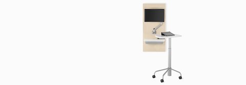 An Intent Solution technology support wall unit in an ash finish with a white surface and a silver monitor arm with monitor.