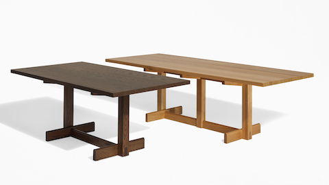 An angle view of two Land tables in oak and umber.