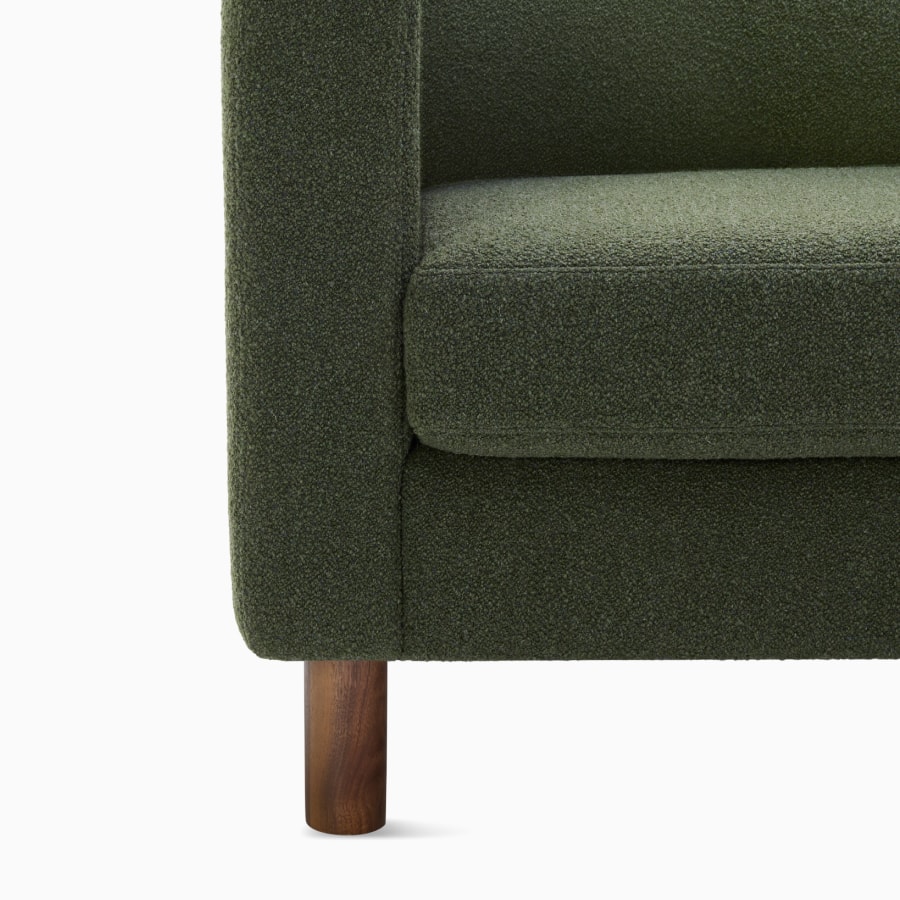Detail view of three seater Lispenard Sofa, 17 inches in dark green textile and 6 inch walnut legs.