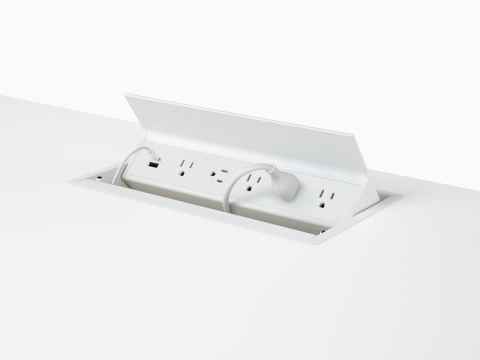 USB-A port, USB-C port with cable, and five A/C power outlets with one cable plugged into an embedded table power source.