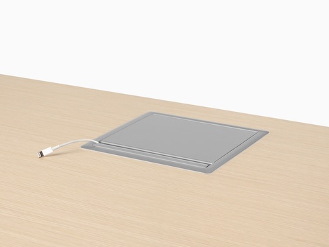 A grommet-mounted Logic power port in the closed position with a USB cable protruding.
