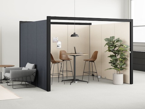 An Eames Table and three Eames Molded Wood Stools in an open Overlay meeting room with beige walls. Bordered by 2 gray Wireframe Chairs and Logic Micro Towers.