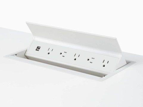 A close-up view of Logic power access in a white work surface.