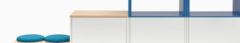 A close up of dark gray Meridian Storage lateral files, featuring two blue open shelves stacked on top.