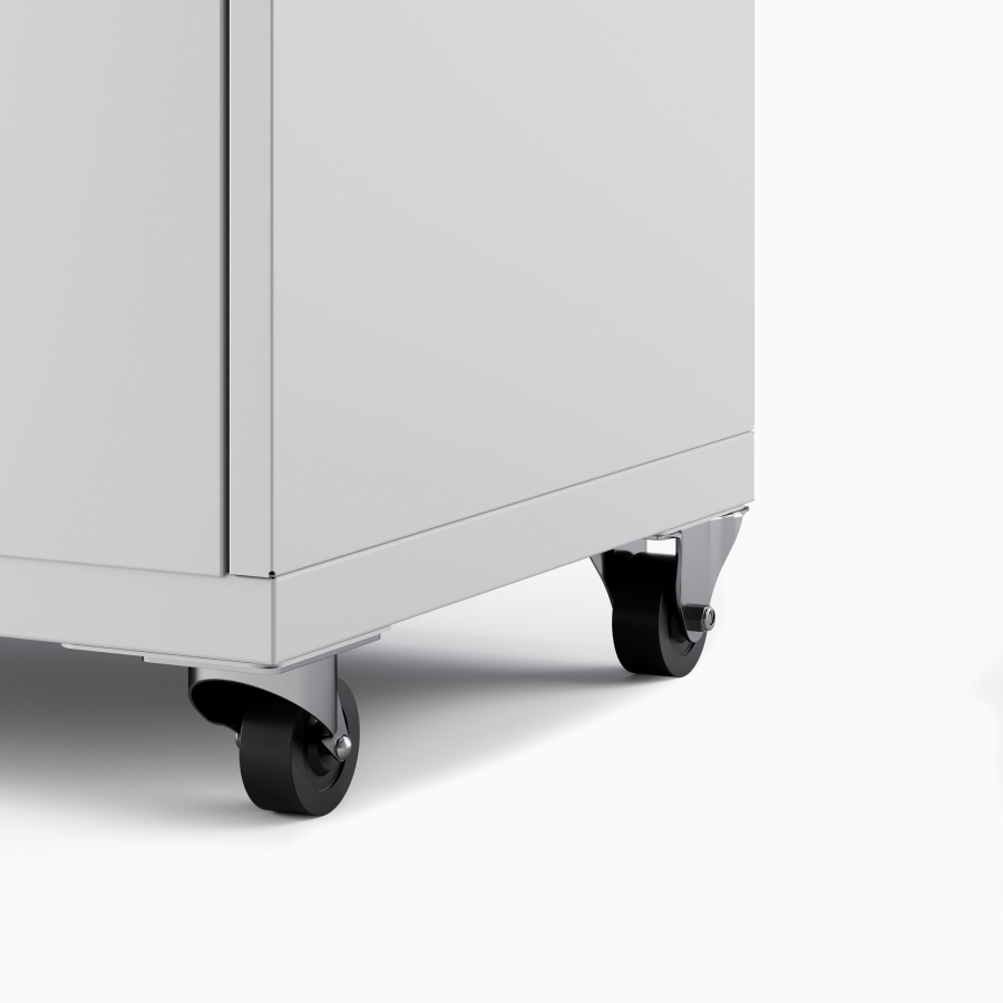 Close up of a light gray Meridian Storage pedestal with casters, viewed from an angle.