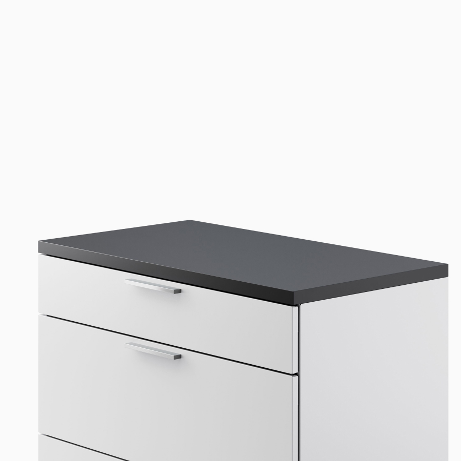 Close up of a light gray Meridian Storage lateral file with a black laminate top, viewed from an angle.