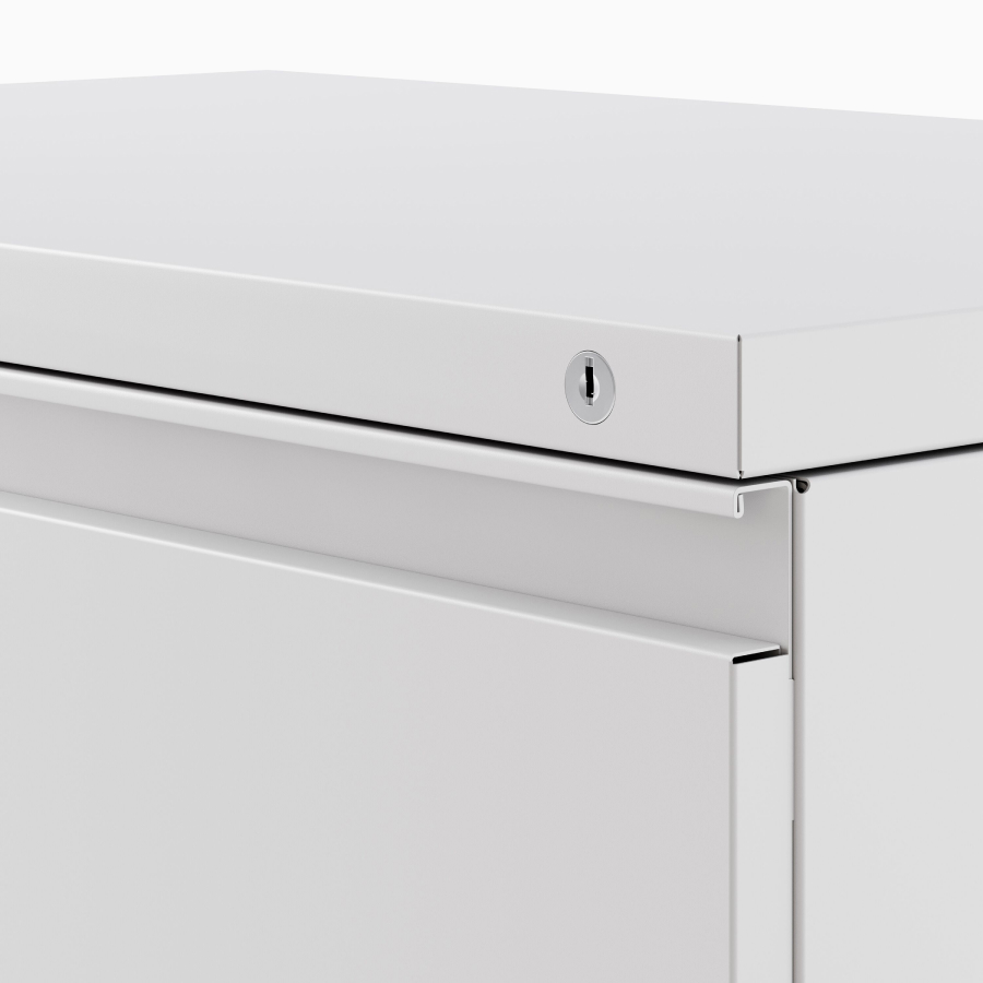 Close up image of a light gray Meridian Storage lateral file with a lock.