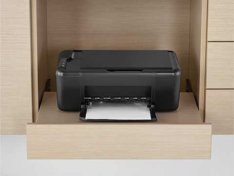 A printer sits on a pull-out printer tray, part of the Mora clinical casework system.