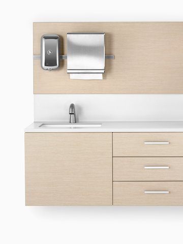 A close-up view of Mora System casework in an ash finish with a white solid surface and integrated sink. Select to go to the Mora System product page.