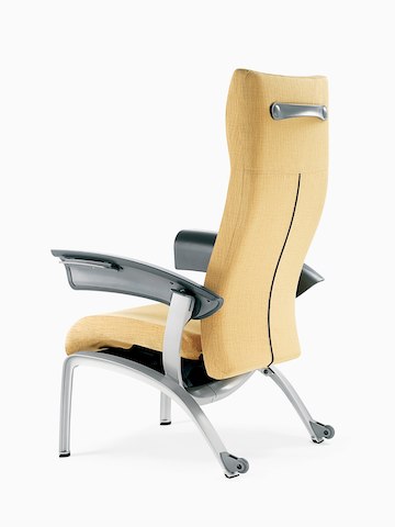 A mustard-coloured Nala Patient Chair, viewed from a three-quarter rear angle.