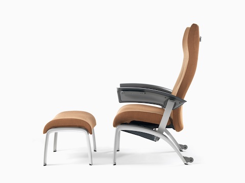 Profile view of a copper-coloured Nala Patient Chair and ottoman.