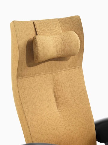 Close view of the upholstered headrest on the back of a mustard-coloured Nala Patient Chair.
