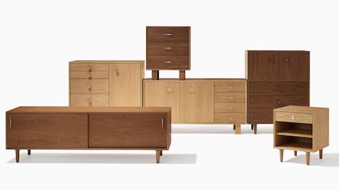 Nelson Basic Cabinet Series in walnut or oak finishes featuring Bedside Table with one drawer and shelf, Cabinet with three drawers, Cabinet with 5 drawers and door, Console with two doors and three drawers, Credenza with two doors and four drawers, and Media Unit with sliding doors.