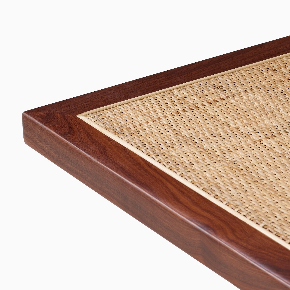 Close up detail of the walnut frame around the cane top of the Nelson Cane Bench.