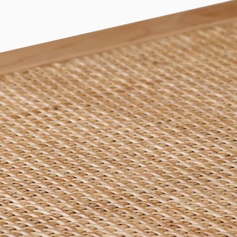 Close up detail of the cane top of a Nelson Cane Bench.
