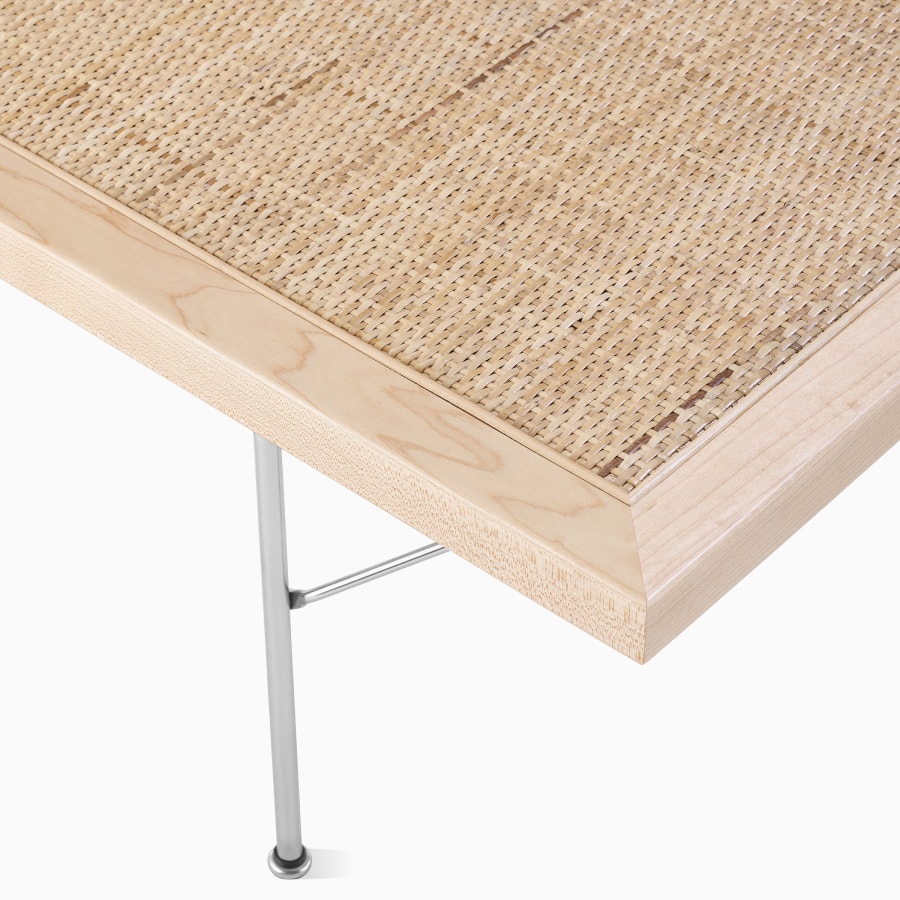 A close up detail of the maple frame of the Nelson Cane Bench.