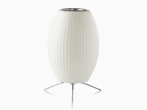 A white Nelson Cigar Tripod Lamp.