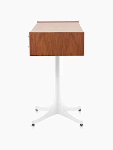 Side view of a horizontal Nelson Miniature Chest with a medium finish and white pedestal base. 