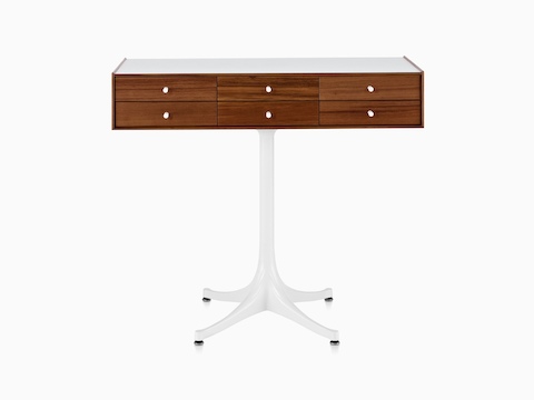 A horizontal six-drawer Nelson Miniature Chest with a medium finish, white top, and white pedestal base. 