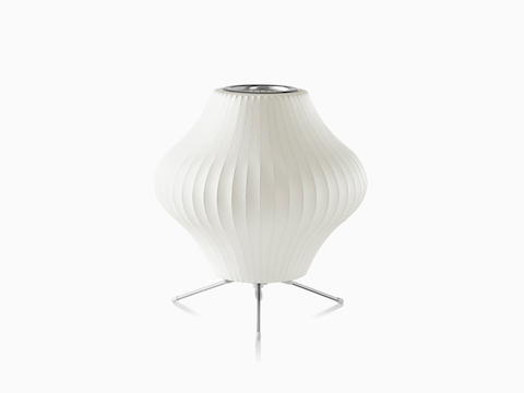 A small Nelson Pear Tripod table lamp.