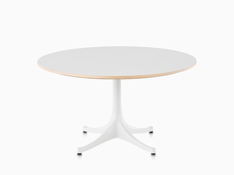 A round Nelson Pedestal Table with a white laminate top and white base. 