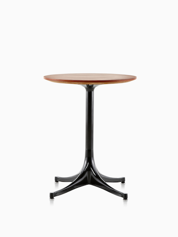 A round Nelson Pedestal Table with a medium wood finish.
