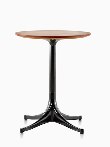 A round Nelson Pedestal Table with a medium wood finish. Select to go to the Nelson Pedestal Table product page. 