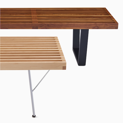 A close up detail of two Nelson Platform Benches, one shorter with a metal base and one longer with an ebonized wood base.