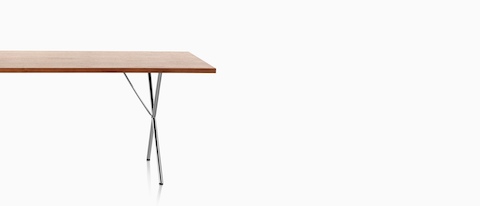 A Nelson X-Leg Table with a light veneer top and chrome legs, viewed from the long side.