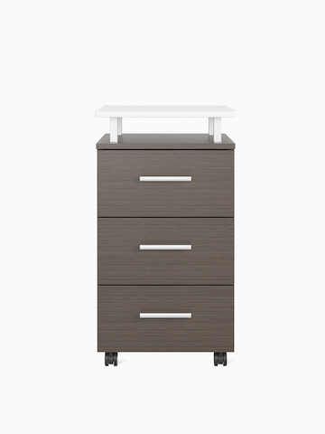 A Nemschoff Bedside Cabinet in a twill graphite finish with a raised top in white Corian and three drawers with a silver profile pull.