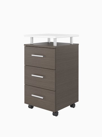 A Nemschoff Bedside Cabinet in a twill graphite finish with a raised top in white Corian and three drawers with a silver profile pull.
