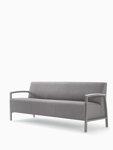 Front three-quarter view of a gray Brava Modern Lounge Seating sofa with solid surface arm caps.