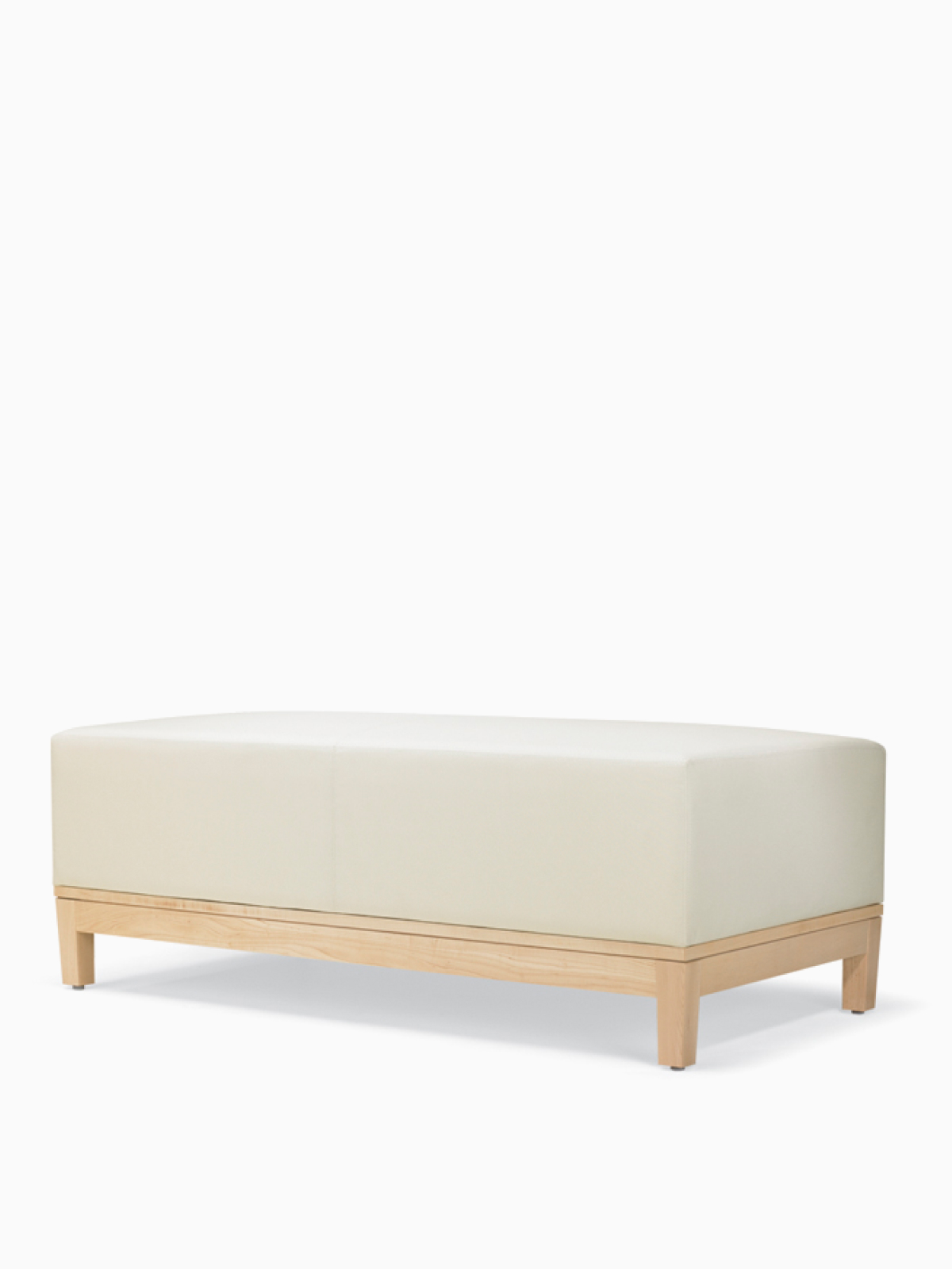 A three-quarter view of a Brava Platform Lounge Bench with maple base and white textile.