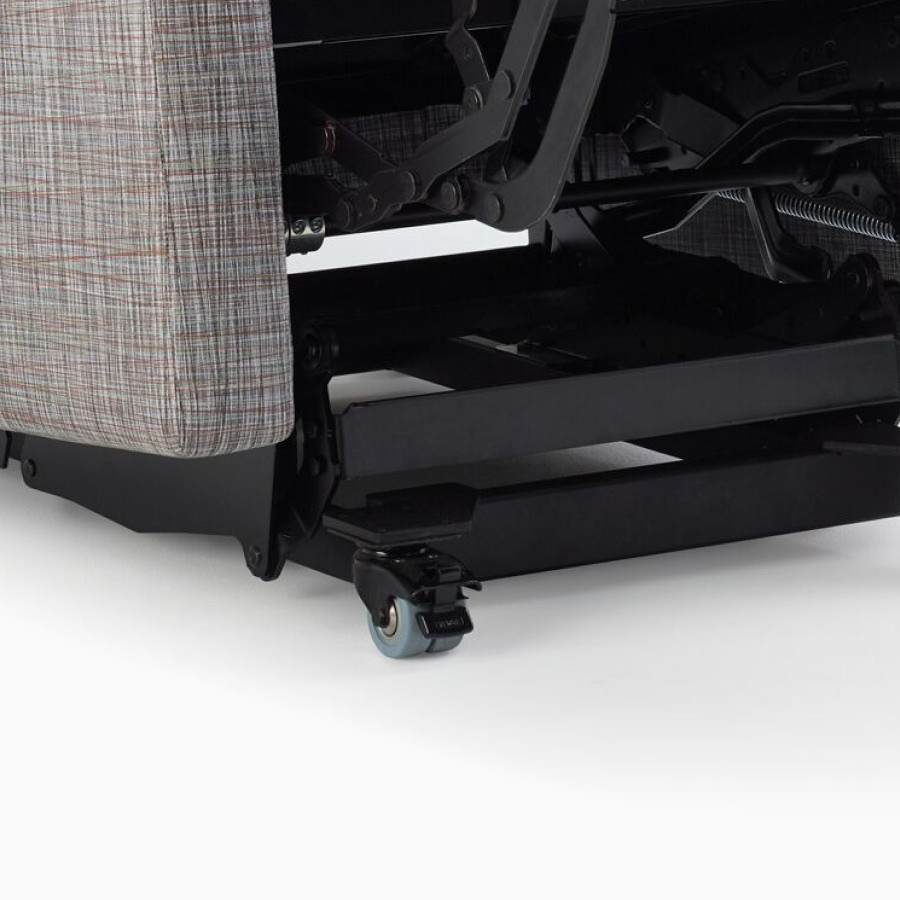 Detail of tilt and roll casters on a Nemschoff Culla Reclining Glider.