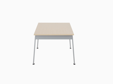 Side view of an Easton Coffee Table with a clear on ash laminate top and metallic silver legs.